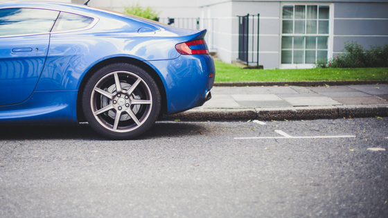 back of a blue car parked outside