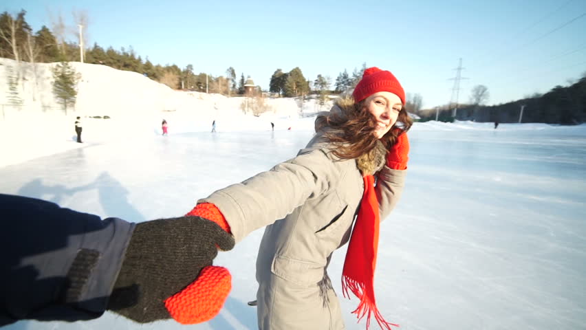 female guiding male ice skating