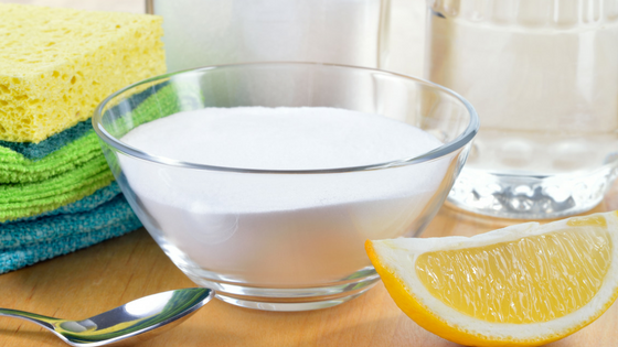 bowl of baking soda and a lemon wedge