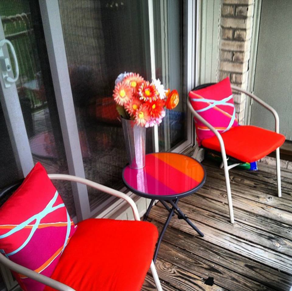 balcony table and chairs with red cushions