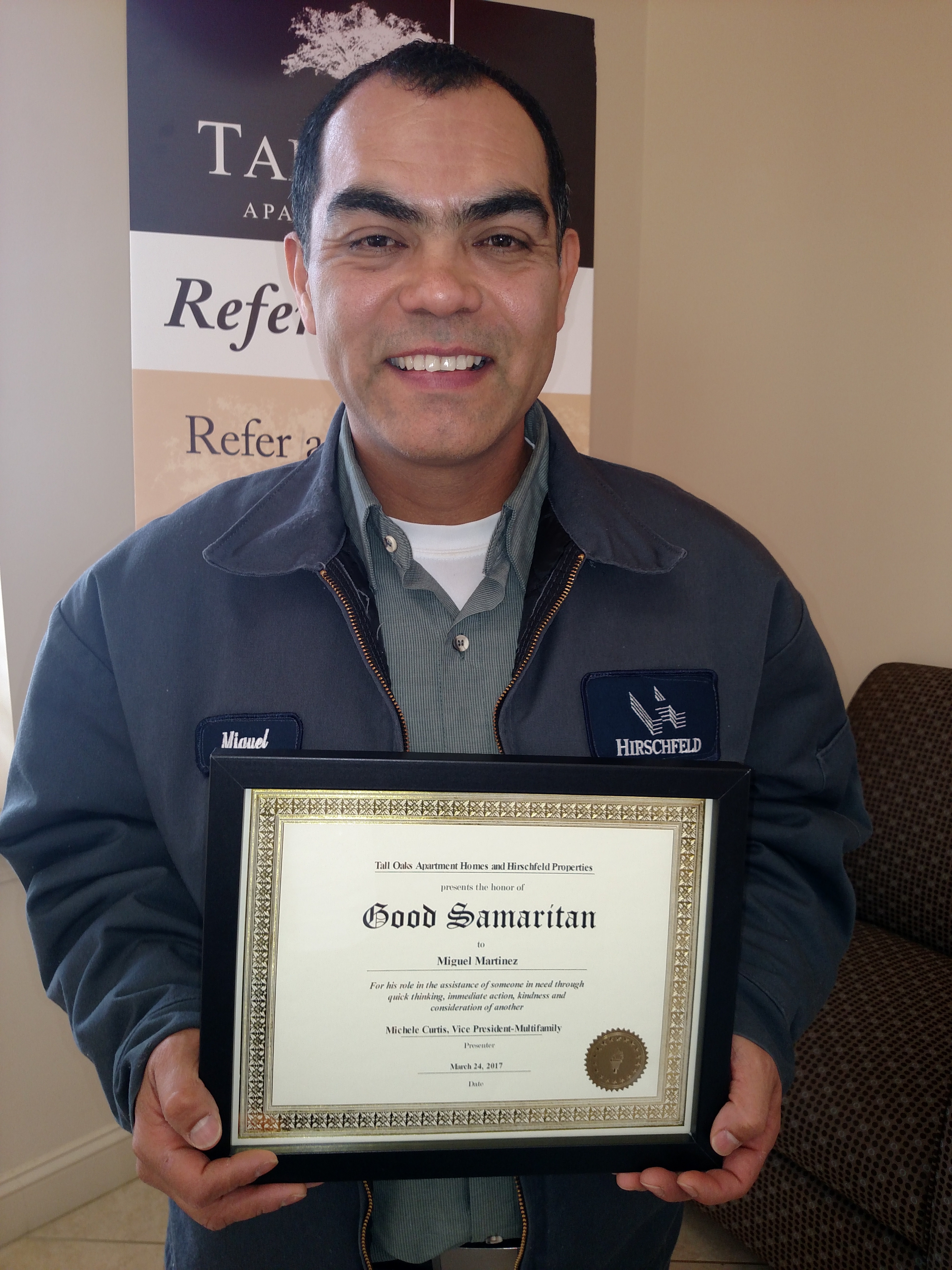 miguel martinez holding his good samaritan award